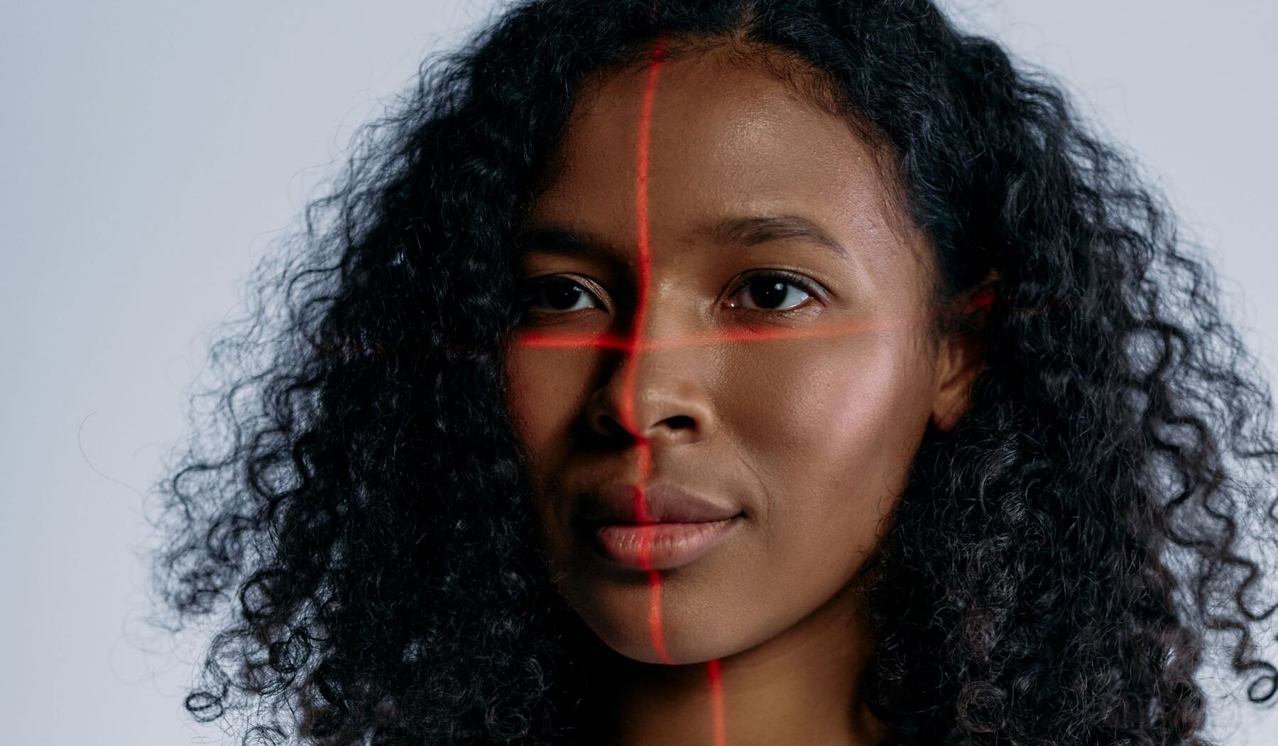 A face crossed by a red scanning line