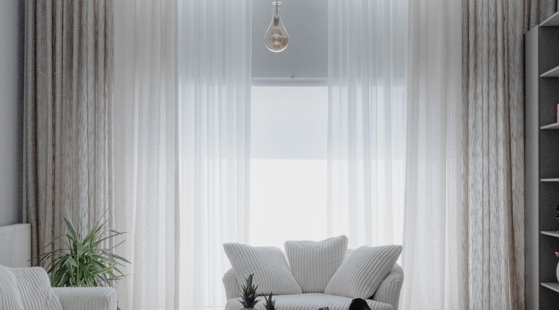 A bright living room with long curtains and a low sofa